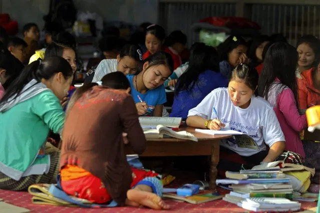 Refugee school students study for final exams inside a monastery which has been set up as temporary refugee camp in KyaukMe, northern Shan State, Myanmar, 21 February 2016. Nearly 4,000 people have fled the conflict zone as heavy fighting has erupted between Restoration Council of Shan State/Shan State Army (RCSS/SSA) and the Ta'ang National Liberation Army (TNLA) in northern Shan State. (Photo by Hein Htet/EPA)