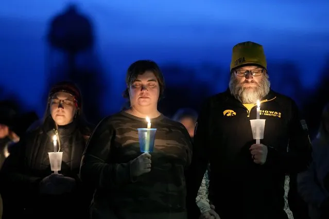 Local residents pray during a candlelight vigil following a shooting at Perry High School, Thursday, January 4, 2024, in Perry, Iowa. (Photo by Charlie Neibergall/AP Photo)