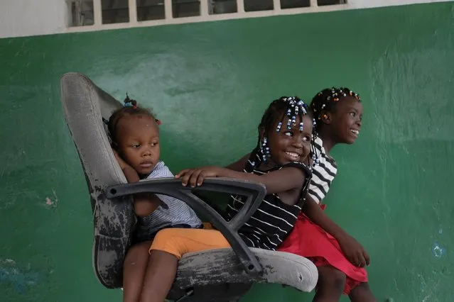 Younaika Ylet, center, plays with other girls at the Immaculate Conception Hospital, also known as the General Hospital of Les Cayes, Haiti, Monday, August 23, 2021, where her mother is being treated one week after the 7.2 magnitude earthquake. The 5-year-old, who was not injured, shares her mother's hospital bed, and they have no home to return to, after the quake brought down their house in Camp-Perrin, killed Younaika's grandfather and two other relatives and seriously injured her uncle. (Photo by Matias Delacroix/AP Photo)