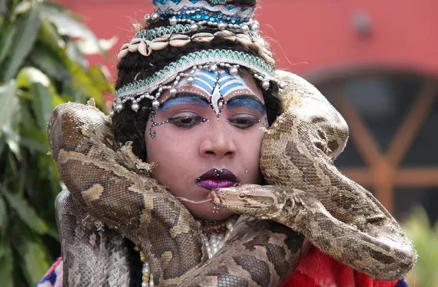 A boy dressed as Hindu Lord Shiva wraps a python around his neck before performing at a park near a temple during the Mahashivratri festival in Chandigarh February 20, 2012. (Photo by Ajay Verma/Reuters)