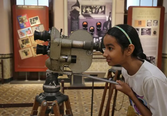 A girl looks through the viewfinder of a Konvas 35mm movie camera inside the National Museum of Indian Cinema in Mumbai, February 19, 2019. (Photo by Francis Mascarenhas/Reuters)