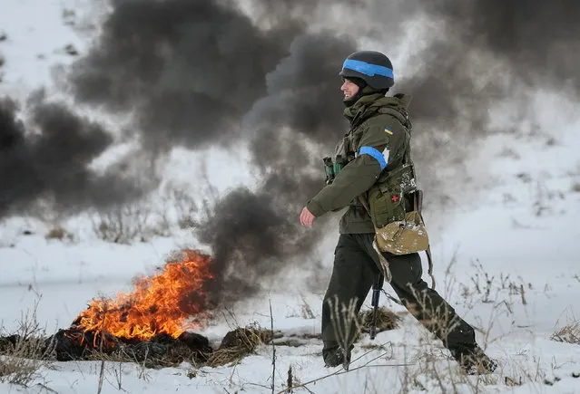 A Ukrainian serviceman attends mock anti-sabotage drills near the border with Russia, in Sumy region, Ukraine on January 20, 2024. (Photo by Gleb Garanich/Reuters)