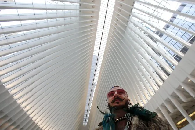 Chad Holobetz talks to his mother on the phone as he walks through the World Trade Center Oculus transportation hub in the Manhattan borough of New York, March 3, 2016. (Photo by Carlo Allegri/Reuters)