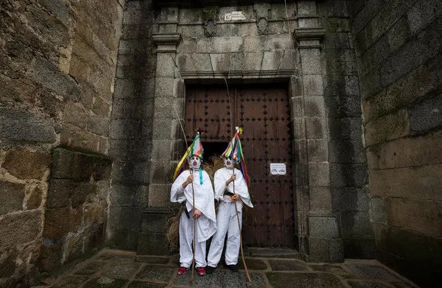 Revellers, dressed as “Zarramache”, pose outside the local church during celebrations to mark Saint Blaise's festivity in Casavieja, Spain February 3, 2017. (Photo by Sergio Perez/Reuters)
