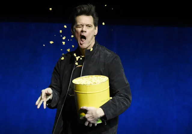 Jim Carrey, a cast member in the upcoming film “Sonic the Hedgehog”, throws popcorn into his face during the Paramount Pictures presentation at CinemaCon 2019, the official convention of the National Association of Theatre Owners (NATO) at Caesars Palace, Thursday, April 4, 2019, in Las Vegas. (Photo by Chris Pizzello/Invision/AP Photo)