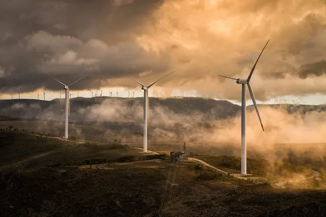 Shortlisted: Clean energy, Serra de São Macário, Portugal, 2021. Wind turbines on the mountaintops are captured moments before sunset on a cloudy day. (Photo by Pedro de Oliveira Simões Esteves/CIWEM Environmental Photographer of the Year 2021)