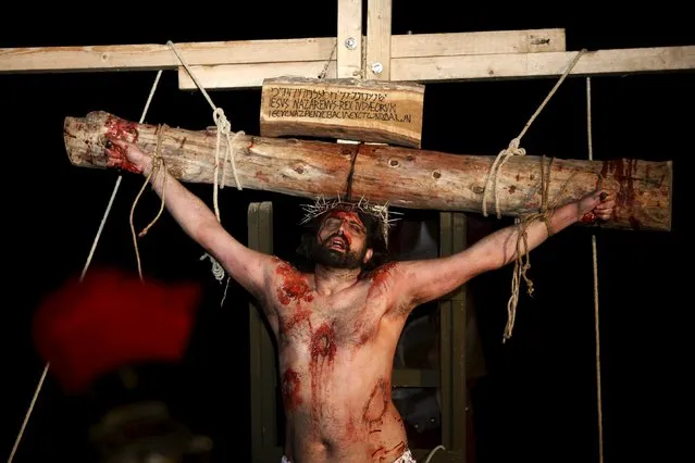 An actor portraying the crucified Jesus Christ takes part in the interactive street-theatre Passion play “Il-Mixja” (The Way), one of a series of Holy Week activities in the run-up to Easter, in the grounds of Mount Carmel Mental Hospital in Attard, outside Valletta, Malta, March 22, 2016. (Photo by Darrin Zammit Lupi/Reuters)