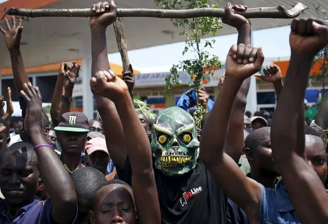 A protester wears a mask to hide his identity during a protest against President Pierre Nkurunziza's decision to run for a third term, in Bujumbura, Burundi, May 11, 2015. (Photo by Goran Tomasevic/Reuters)