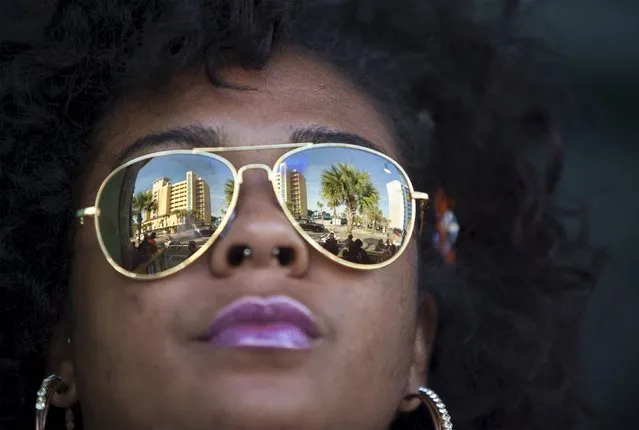 Kenyatta Redd of Martinsville, Virginia watches the crowds from the Beach House Bar & Grill during the 2015 Atlantic Beach Memorial Day BikeFest in Myrtle Beach, South Carolina May 22, 2015. (Photo by Randall Hill/Reuters)