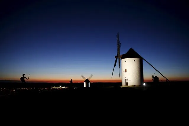 Sculptures of Don Quixote (L) and his ladyship Dulcinea (C) are seen at dusk by the windmills of Mota del Cuervo, Spain, April 6, 2016. The arid central Spanish region of La Mancha is the setting for “Don Quixote”, the seventeenth-century novel by Miguel de Cervantes. Four hundred years after his death, references to the characters of Don Quixote, his loyal squire Sancho Panza and his beautiful lady Dulcinea abound in the surrounding villages from sweet treats to theatre productions involving livestock. Cervantes did not give away the name of the birthplace of Don Quixote, a middle-aged gentleman who becomes obsessed with chivalrous ideals. But many identify the village of Argamasilla de Alba as his hometown. The anniversary of Cervantes’ death is marked on the 23 April. (Photo by Susana Vera/Reuters)