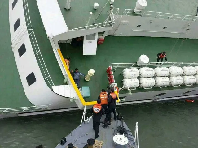 Coast Guard officers conducting a rescue operation around the passenger ferry Sewol sinking in waters off the southwestern coast of South Korea. (Photo by EPA)