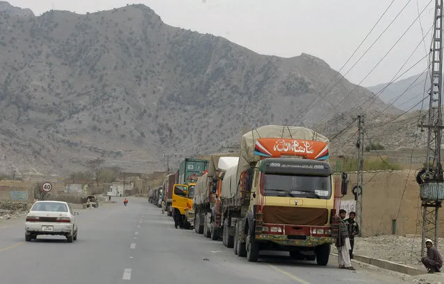Truck drivers stand beside their trucks while they waiting for border opening at a highway leading to Torkhum, a border crossing between Pakistan Afghanistan, Monday, March, 20, 2017. Pakistan's prime minister ordered the reopening of the country's border with Afghanistan on Monday, ending a protracted closure that has cost businesses on both sides millions of dollars and deepened tensions between the two neighbors. (Photo by Matiullah Achakzai/AP Photo)