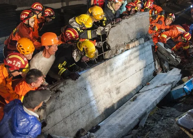 Rescue workers remove debris at the site after a shoe factory building collapsed in Wenling, Zhejiang province, July 4, 2015. (Photo by Reuters/Stringer)