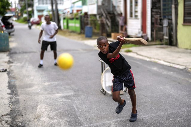 People play cricket on the street in the Charlestown neighborhood of Georgetown, Guyana, Sunday, June 2, 2024. Guyana is one of the venues for the T20 Cricket World Cup. (Photo by Ramon Espinosa/AP Photo)