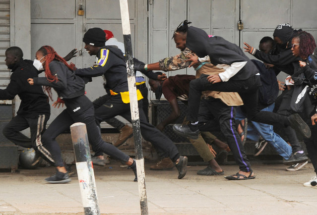 People run after police officers used teargas to disperse protesters during a demonstration over police killings of people protesting against Kenya's proposed finance bill 2024/2025, in Nairobi, Kenya, on June 27, 2024. (Photo by John Muchucha/Reuters)