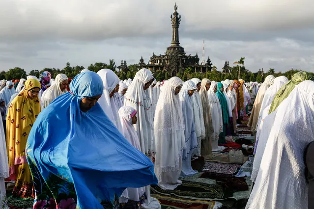 Muslims pray during mass to celebrate Eid-ul Fitr  on July 17, 2015 in Denpasar, Bali,  Indonesia. The two-day holiday, Eid ul-Fitr, marks the end of Ramadan, the Islamic month of fasting and begins after the sighting of a new crescent moon. (Photo by Putu Sayoga/Getty Images)