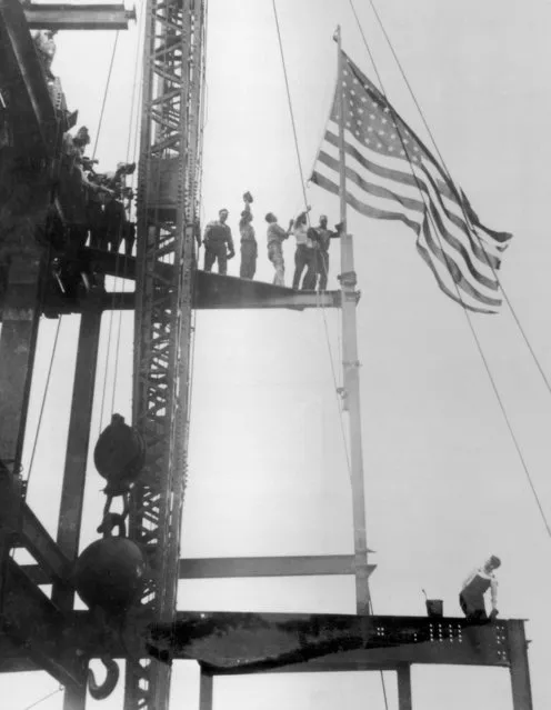 Construction workers celebrate the completion of the iron work on the Empire State Building, Manhattan, circa 1930. The building was constructed between 1930 and 1931. (Photo by FPG/Hulton Archive/Getty Images)