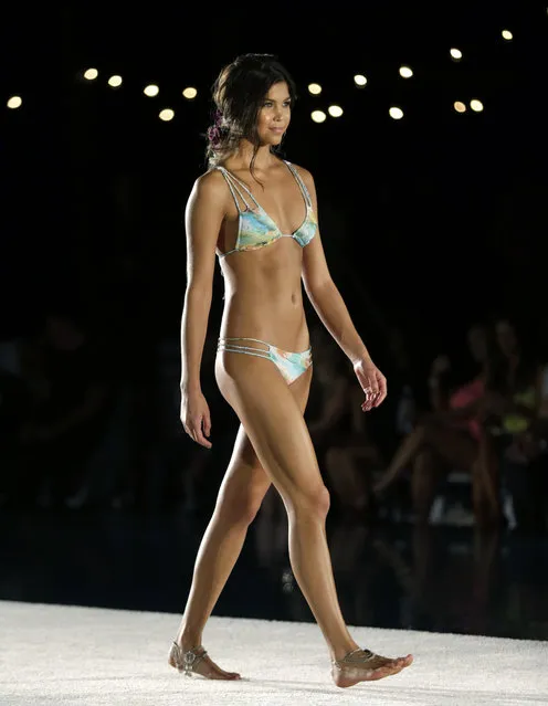 A model walks down the runway during the San Lorenzo Bikinis swimwear show as part of Funkshion Fashion Week Swim, Saturday, July 18, 2015, in Miami Beach, Fla. (Photo by Lynne Sladky/AP Photo)