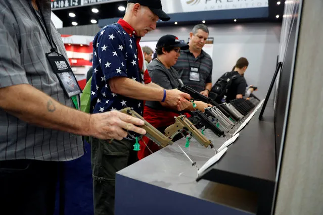 Attendees visit the trade booths during the National Rifle Association's annual meeting in Louisville, Kentucky, May 21, 2016. (Photo by Aaron P. Bernstein/Reuters)