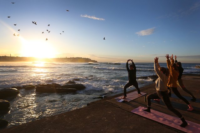 Instructor Romy Morssinkhof from “Yoga By The Sea” leads a free yoga session to celebrate International Day of Yoga and welcome the winter solstice at Bondi Beach on June 21, 2024 in Sydney, Australia. The International Day of Yoga is celebrated annually on June 21st to recognise the ancient Indian practice of yoga and promote its benefits for physical and mental well-being globally. June 21st also marks the winter solstice in the Southern Hemisphere, the shortest day of the year when the Earth's South Pole is tilted furthest away from the Sun. (Photo by Lisa Maree Williams/Getty Images)