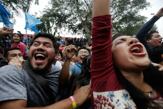 Supporters of presidential candidate Pedro Pablo Kuczynski celebrate in Lima, Peru, Sunday, June 5, 2016. Early exit polls show presidential candidate Pedro Pablo Kuczynski with a slight lead over his rival Keiko Fujimori in Peru's runoff presidential election. (Photo by Martin Mejia/AP Photo)