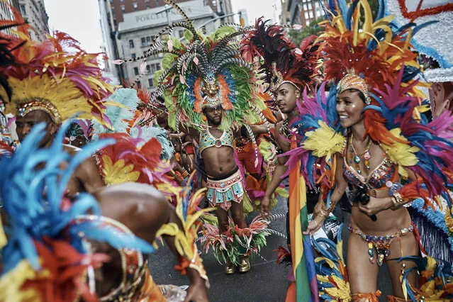 Members of the Caribbean pride pause during the New York City Pride Parade on Sunday, June 25, 2017, in New York. (Photo by Andres Kudacki/AP Photo)