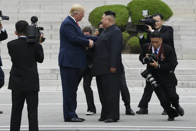 President Donald Trump walks to the North Korean side of the border with North Korean leader Kim Jong Un at the border village of Panmunjom in the Demilitarized Zone, South Korea, Sunday, June 30, 2019. (Photo by Susan Walsh/AP Photo)