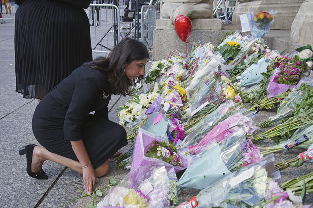 Home Secretary Suella Braverman looks at flowers on the steps of Nottingham Council House in Nottingham, Britaim Thursday, June 15, 2023 after three people were killed and another three hurt in connected attacks on Tuesday morning. Police in England are working to piece together details of a knife and van attack that killed two 19-year-old students and a 65-year-old man in the city of Nottingham. (Photo by Peter Byrne/PA Wire via AP Photo)