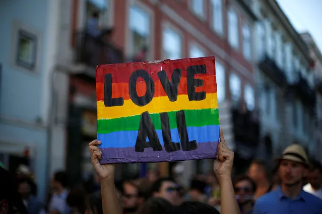 A participant holds up a sign while marching during a Gay Pride Parade in downtown Lisbon, Portugal June 18, 2016. (Photo by Rafael Marchante/Reuters)