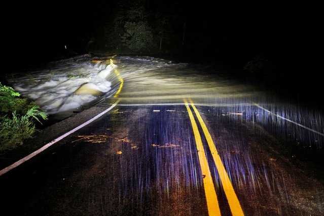 Flood waters wash over Guy Ford Road bridge on the Watauga River as Hurricane Helene approaches in the North Carolina mountains, in Sugar Grove, North Carolina, U.S. September 26, 2024. (Photo by Jonathan Drake/Reuters)