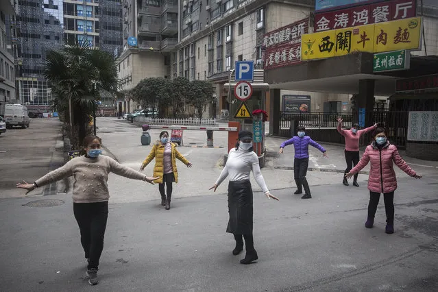 A group of women wear protective masks while exercising on January 27, 2020 in Wuhan, China. As the death toll from the coronavirus reaches 80 in China with over 2700 confirmed cases, the city remains on lockdown for a fourth day. (Photo by Getty Images/China Stringer Network)