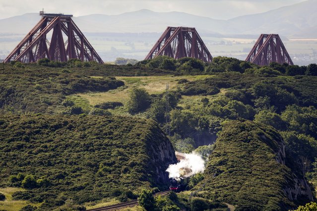 The Flying Scotsman locomotive crosses the Forth Bridge, as it makes a journey to Aberdeen during the steam train’s centenary tour on July 03, 2023 in Edinburgh, Scotland. In February, the famous locomotive marked 100 years since it entered into service. Today, it rail enthusiasts got the chance to catch a glimpse of The Flying Scotsman as it traveled from Edinburgh to Aberdeen. (Photo by Jeff J. Mitchell/Getty Images)