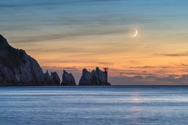 “Crescent Moon over the Needles”, Ainsley Bennett (UK). The 7% waxing crescent moon setting in the evening sky over the Needles Lighthouse at the western tip of the Isle of Wight. Despite the moon being a thin crescent, the rest of its shape is defined by sunlight reflecting back from the Earth’s surface. (Photo by Ainsley Bennett/National Maritime Museum/The Guardian)