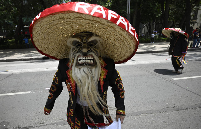 Indigenous people participate in a march commemorating the International Day of the World's Indigenous Peoples in Mexico City on August 9, 2023. (Photo by Alfredo Estrella/AFP Photo)