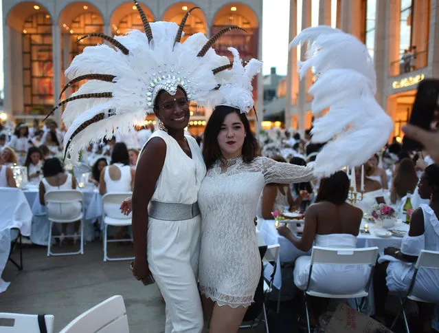 Guests attend the annual New York City Diner en Blanc, August 22, 2017 held this year at the plaza at Lincoln Center. (Photo by Timothy A. Clary/AFP Photo)
