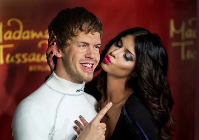 German model Micaela Schaefer, right, poses next to the new waxwork figure of Formula One World Champion German Sebastian Vettel at Madame Tussauds in Berlin, Germany on July 27, 2012. (Photo by Gero Breloer/Associated Press)