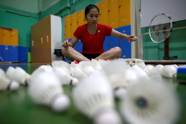 Thailand's badminton player Ratchanok Intanon (C), who hopes to win gold at the Rio Olympics, collects shuttlecocks after an afternoon training session at a gym in Bangkok, Thailand, June 22, 2016. (Photo by Athit Perawongmetha/Reuters)
