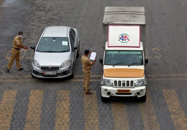 Police officers stop vehicles and check their papers on a highway during 21-day nationwide lockdown to limit the spreading of coronavirus disease (COVID-19), in Kochi, India, March 25, 2020. (Photo by Sivaram V/Reuters)