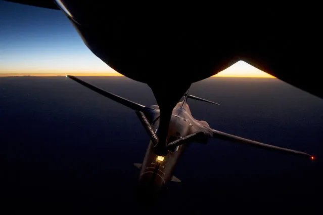 A U.S. Air Force B-1B Lancer supersonic bomber receives fuel from a KC-135 Stratotanker over northern Iraq after conducting air strikes in Syria against ISIL targets September 27, 2014. (Photo by Reuters)