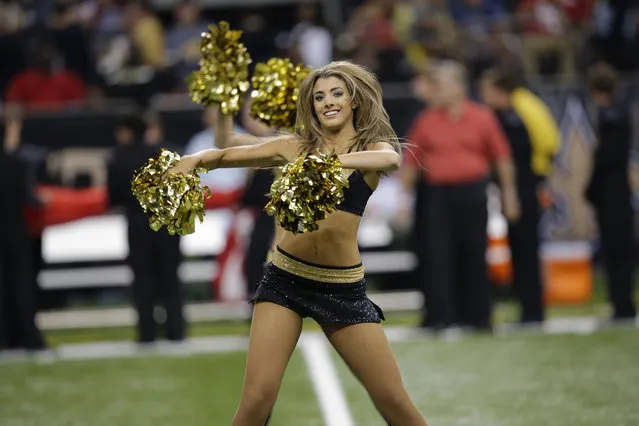 New Orleans Saints cheerleaders perform before an NFL football game against the San Francisco 49ers in New Orleans, Sunday, November 17, 2013. (Photo by Bill Haber/AP Photo)