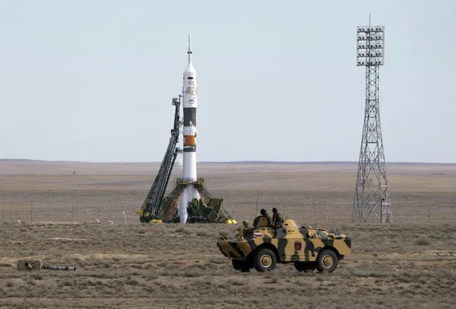 An armoured personnel carrier (APC) drives in front of the Soyuz TMA-18M spacecraft shortly before the launch with the international crew at the Baikonur cosmodrome, Kazakhstan, September 2, 2015. (Photo by Shamil Zhumatov/Reuters)