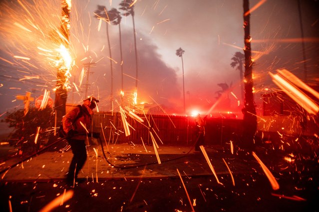 Firefighters battle the Palisades Fire as it burns during a windstorm on the west side of Los Angeles, California, U.S. January 7, 2025. (Photo by Ringo Chiu/Reuters)