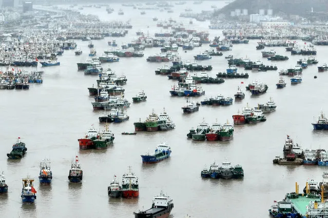 An aerial view shows vessels moored at a fishing port as Typhoon Muifa approaches, in Zhoushan, Zhejiang province, China on September 13, 2022. (Photo by Reuters/China Daily)