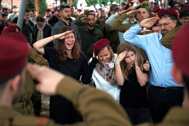Family members react while saluting during the funeral of Master Sgt. Daniel Weidenbaum on January 14, 2024 in Ra'anana, Israel. The Israel Defense Forces announced that Weidenbaum was killed on Friday while fighting in central Gaza. (Photo by Amir Levy/Getty Images)