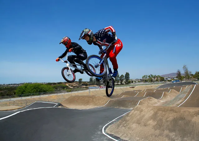 U.S. Olympic BMX athlete Connor Fields (R) goes over a jump as he trains with New Zealand's Trent Jones at the Olympic Training Center in Chula Vista, California, United States, July 23, 2016. (Photo by Mike Blake/Reuters)