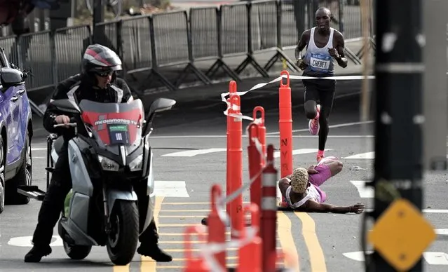 Brazil's Daniel Do Nascimento reacts after collapsing during the elite men's race before being overtaken by Kenya's Evans Chebet during the 2022 TCS New York City Marathon on November 06, 2022 in New York City. (Photo by Jeenah Moon/Reuters)