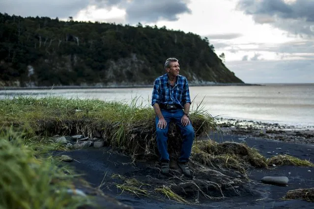 Alexander Kisleiko, director of the Kurile Nature Reserve, poses for a picture on the coast of the Okhotsk Sea on the Southern Kurile island of Kunashir September 16, 2015. Russian residents of the island chain at the centre of a dispute between Japan and Russia that has held up a treaty to formally end World War Two hope a diplomatic solution will lure tourists and investment to help refurbish rickety infrastructure. (Photo by Thomas Peter/Reuters)