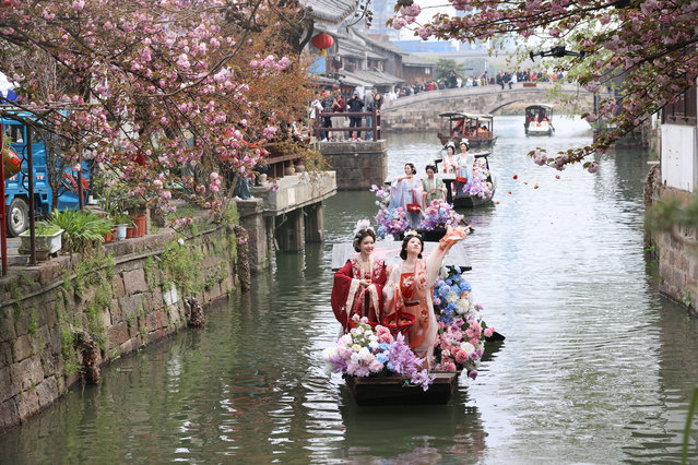 The “silk blossom fairy”, adorned in traditional attire, take boat rides and scatter flowers to the villagers during the folklore parade, representing the farmers' hope for a prosperous season of silk production, during the Silkworm Flower Folk Customs Fair on April 4, 2025 in Huzhou, Zhejiang Province of China. The Fair was held in silk-producing areas of east China's Zhejiang Province on the Qingming Festival, or the Tomb-Sweeping Day, to pray for favorable weather and a bountiful harvest. (Photo by Dong Xuming, Yao Haixiang/Zhejiang Daily Press Group/VCG via Getty Images)