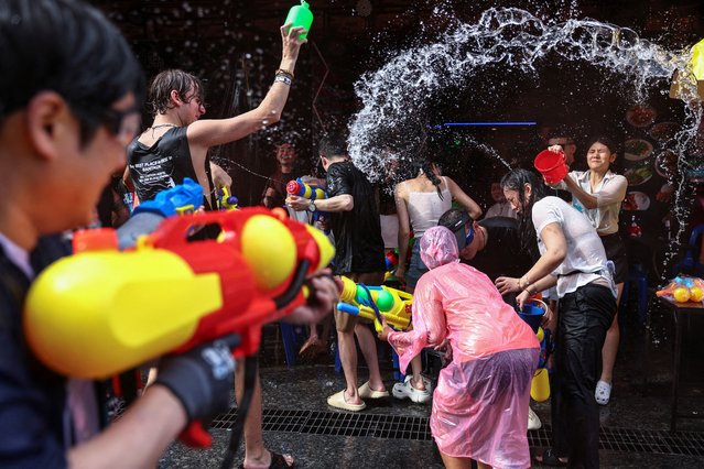 Revellers play with water as they celebrate the Songkran holiday, which marks the Thai New Year, in Bangkok, Thailand, on April 12, 2025. (Photo by Chalinee Thirasupa/Reuters)