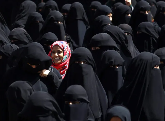 A Yemeni girl stands among burqa clad women during a rally protesting against Saudi-led coalition airstrikes outside the UN offices in Sana'a, Yemen, 04 October 2015. According to reports, the United Nations Children's Fund (UNICEF) has underscored the devastating toll six months of violence and Saudi-led coalition airstrikes has taken on the children of Yemen, where at least 500 have lost their lives. (Photo by Yahya Arhab/EPA)